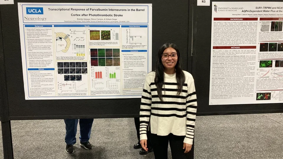 Ms. Brenda Vasquez posing in front of her poster at the SfN 2023 Annual Meeting
